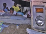 Haitian family sleeping<br>outside after earthquake.<br>Credits: VOA