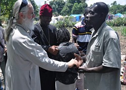 Fr. Daniel McKenzie, administrator<br>of the Haiti ROCOR mission, meets <br>parishioners in Port-au-Prince.<br>April 2010 photo: Serge McKenzie